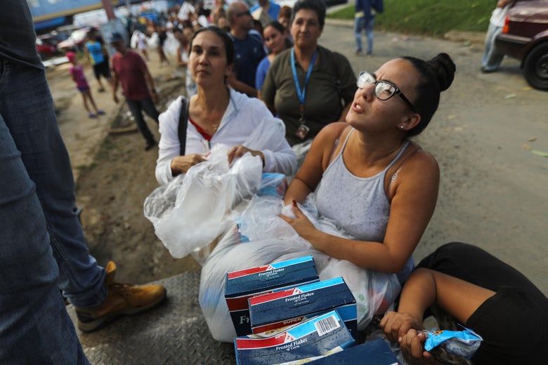 People wait on line for free food and health supplies passed out by the nonprofit Lets Give on December 19, 2017 in Utuado, Puerto Rico.